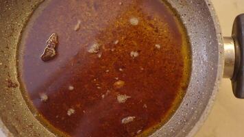 used cooking oil in frying pan. video