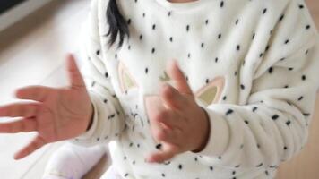 child clapping hands and smiling, sitting on sofa . video