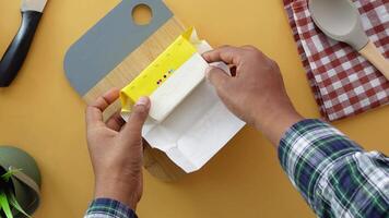 slice of a butter on a paper on table video