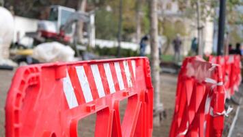 Warning sign of repair work put near striped red and white tape hanging on sticks. video