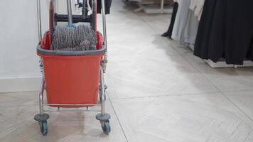 A gaspowered cleaning machine with a rolling cart, broom, and mop video