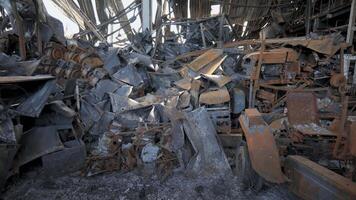 Burnt goods and equipment inside the warehouse. Destroyed logistics hub as a result of a rocket attack by Russian troops near Kyiv. War between Russia and Ukraine. video