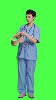 Front view Specialist presenting cervical neck collar used for physical therapy and trauma after an accident or fracture, greenscreen backdrop. Nurse shows orthopedics brace to help with spine injury. Camera A. video