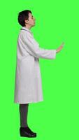 Profile Woman health specialist showing no sign and being furious against greenscreen backdrop, expressing negativity and rage in studio. Angry physician screaming and shouting at people. Camera A. video