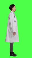 Profile Physician being uncertain about something in studio, shrugging and feeling clueless about the right answer. Doctor doing i dont know symbol against greenscreen backdrop, confusion. Camera A. video