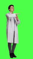 Side view Woman physician doing timeout gesture against greenscreen backdrop, asking for a work break after multiple examinations. Doctor showing pause or stop symbol, feeling tired. Camera A. video