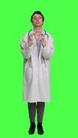 Front view Angry physician yelling at people and being aggressive in studio, getting mad and furious at something against greenscreen backdrop. Irritated annoyed medic screaming, being displeased. Camera A. video