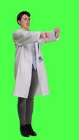 Side view Displeased physician showing thumbs down symbol against greenscreen backdrop, expresses negativity and rejection. Doctor feeling dissatisfied and disagreeing with an idea, dislike sign. Camera A. video