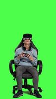 Front view Player enjoying cyberspace gaming competition with vr glasses on smartphone app, playing mobile video games with interactive virtual reality headset. Woman plays tournament, greenscreen. Camera A.