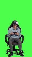 Front view Frustrated gamer losing at video games on mobile phone app, playing with vr glasses and artificial intelligence against greenscreen. Displeased furious girl gets angry with her failure. Camera A.