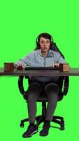 Front view POV of frustrated gamer playing online video games and losing, feeling disappointed with her lost championship on computer. Girl plays gaming competition on pc, greenscreen backdrop. Camera A.