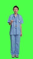 Front view Displeased irritated nurse shouting no and arguing with someone against greenscreen backdrop, showing rage and anger while she wears hospital scrubs. Aggressive medical assistant. Camera A. video