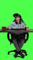 Front view POV of gamer using virtual reality on pc video games and winning, feeling proud and happy with her championship victory. Woman with vr headset at desk playing shooter contest. Camera A.