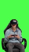 Front view Frustrated gamer losing at video games on mobile phone app, playing with vr glasses and artificial intelligence against greenscreen. Displeased furious girl gets angry with her failure. Camera B.