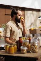 Man in zero waste store smells lemons, making sure they are handpicked and farm grown. Green living customer thoroughly checking local supermarket food items are chemicals free photo