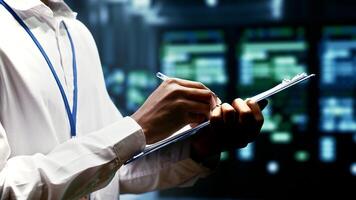 Close up of worker writing info on supercomputer cybersecurity dangers arising due to unsecured network connections. Technician making sure supercomputer farm is invulnerable to virus attacks photo