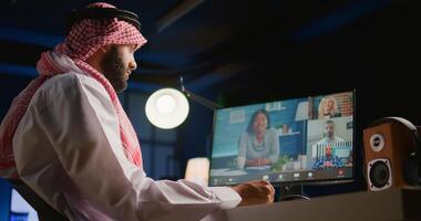 Arab supervisor holding online teleconference meeting with remotely working subalterns, checking on task progress. Muslim business executive at home discussing with employees during videocall photo