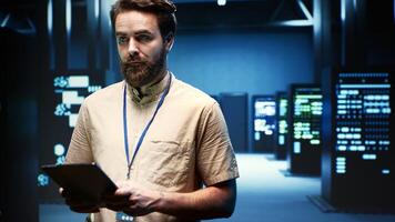 Expert preparing server room recovery plan monitoring data center energy consumption across components, ensuring sensors are functioning optimally, performing routine disk checks photo