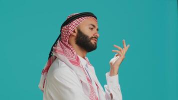 Middle eastern man being puzzled and thinking about solution, being interested about a subject and trying to find answer. Young adult being pensive in studio, wondering about new idea. photo