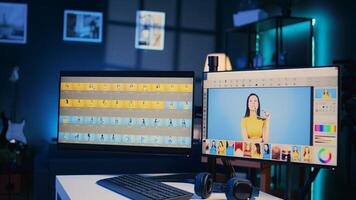 Photo retouching software interface on computer in empty blue neon lit photography studio. Photography organizing program displayed on multi monitors PC setup on multimedia agency desk, zoom out shot