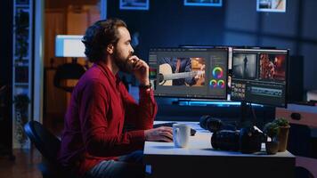 Videographer arriving at work in media agency office, ready to start color correcting raw footage. Video editor editing video renders while drinking , using software to make montage from clips photo