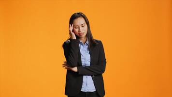 Business manager deals with tension and headache in studio, rubbing temples to ease pain. Young woman feeling unwell with painful migraine, working under stress and experiencing burnout. photo