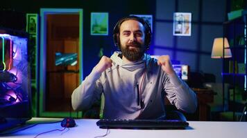 Esports player recording himself playing videogames in front of online viewers during livestream, providing engaging commentary while battling foes. Pro gamer streaming gaming session photo