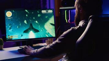 Man arriving at home, ready to relax by shooting asteroids in spaceship flying singleplayer game. Gamer sitting in gaming chair, navigating universe in simulation game, close up photo