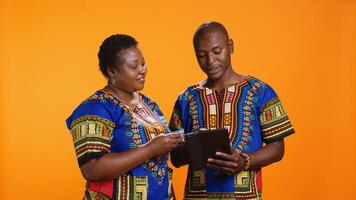 African american couple buying clothes on sale with web payment, enjoying online shopping session using tablet. Young married people looking for items on store website or app, mobile gadget. photo