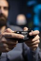 Close up shot of controller held by gamer at home gaming and enjoying leisure time. Focus on gamepad used by man in blurry background in neon lit living room playing videogame on console, relaxing photo