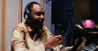 Zoom in on african american man on podcast discussing with guest during marathon stream for humanitarian cause. Host chatting with celebrity, gathering donations from audience during internet show photo