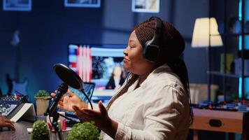 Internet show host speaking with guest during live broadcast for social media website, listening to her opinion. Internet influencer using professional gear to record podcast photo