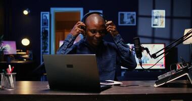 Portrait of african american man starting live broadcast on streaming platform, greeting viewers. Cheerful internet star arriving in studio, ready to create content for his audience photo