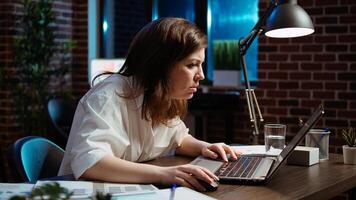 Employee upset by negative response received from customer while discussing business matters over email messages. Worker exasperated, putting head in head, frustrated by too much work in office photo