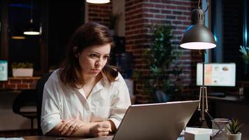 Employee calls manager remotely using internet videocall to ask for feedback on project progress. Worker in brick wall office requesting assistance from team leader in teleconference meeting, camera A photo