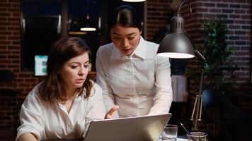 Worker brainstorming with colleague to write email at computer desk, finalizing deal with business partners. Coworkers using laptop to make agreement over internet with associates, zoom in shot photo