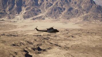 A helicopter flying over a mountain range in the desert video