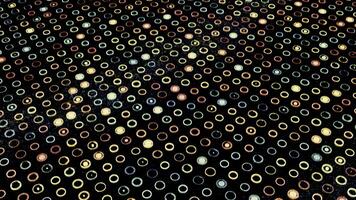 Moving surface with many small round shaped silhouettes and colorful blinking circles inside them, seamless loop. Animation. Light flares flowing all over the black screen, concept of energy. photo