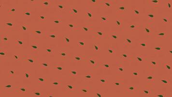 Seamless loop animation. Animation. Abstract colorful pattern of small green leaves rotating and moving down on the red background. Seamless loop animation photo