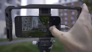 Professional shooting on phone with memory card. Action. External disk for recording material from phone. Shooting on phone with stabilizer and external memory photo