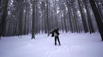 Man dancing in winter forest. Media. Stylish man moves like in clip in winter forest. Shooting clip of rapper dancing in winter forest photo