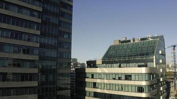 Top view of facade of beautiful glass skyscrapers. Stock footage. Beautiful glass skyscrapers in sunny summer day. Beautiful architecture of glass skyscrapers in center of modern city photo