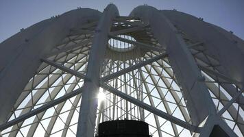 Dome construction of building. Stock footage. Beautiful frame construction of white dome on building. Modern architecture of building with through dome frame on background sky photo