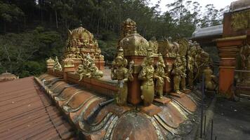 hindú templo con dorado estatuas acción. rojo templo con dorado budista estatuas templo de hindú origen en sri lanka foto