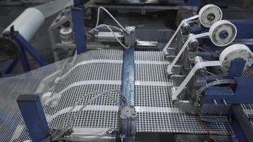 Automated Polymer Mesh Machine. Creative. Machines laying heating wires on polymer grid. Industrial production of modules for floor heating photo