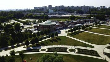 Top view of historic building with garden patterns on sunny day. Creative. Landscape design of garden with patterns near historic building. Historical complex with garden on background of modern city photo