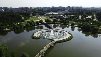 Top view of fountain in pond and historical palace. Creative. Amazing fountain in lake with pedestrian bridges at historical palace. Historical complex with fountains, gardens and buildings photo
