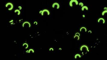 Small neon rings move in space. Design. Neon rings vibrate in space with waves and reflections. Luminous bokeh rings vibrate in dark photo