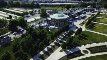 Top view of historic building with garden patterns on sunny day. Creative. Landscape design of garden with patterns near historic building. Historical complex with garden on background of modern city photo