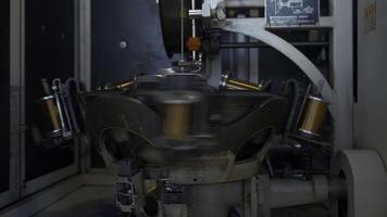 Rotating machine with copper wire winding. Creative. Automated machine for winding copper wire on coils. Rotating multiple coils for winding wires in production photo